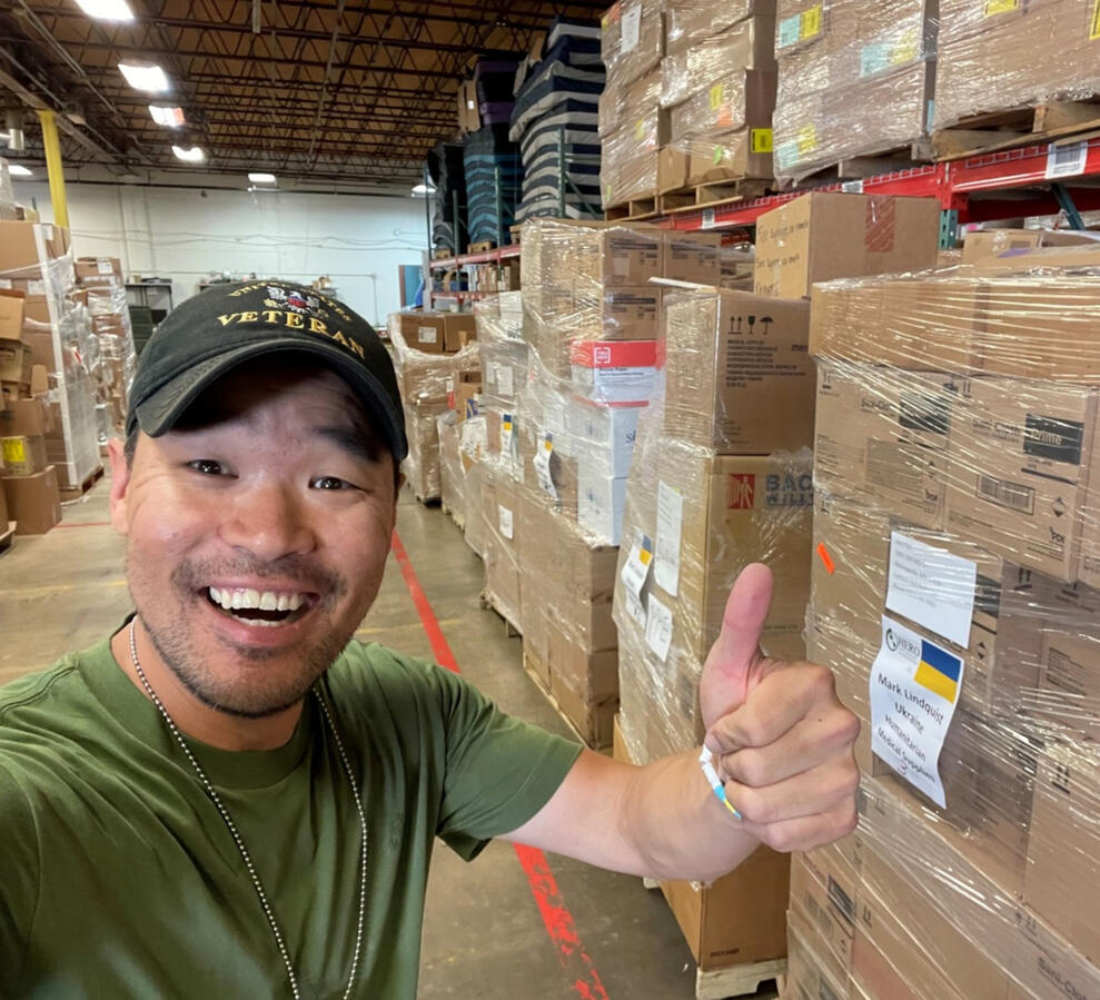 Mark J. Lindquist pictured next to pallets of medical supplies he delivered to Ukraine